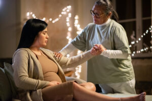 Expecting mother relaxing during gentle chiropractic adjustment.