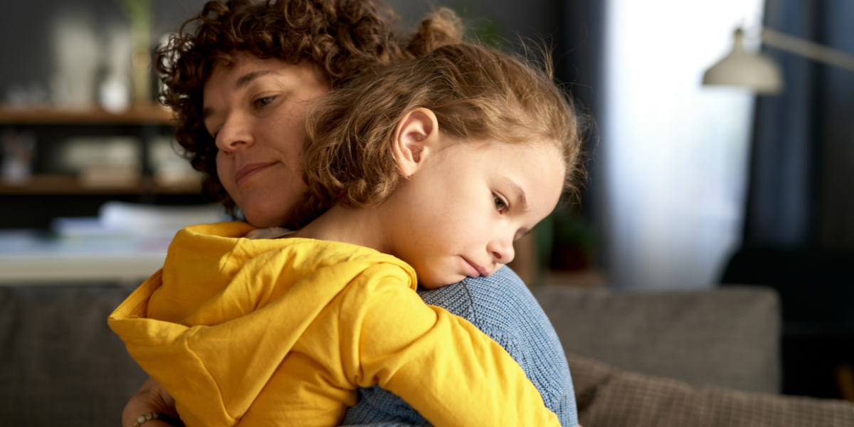 Parent comforting child with sensory and focus struggles