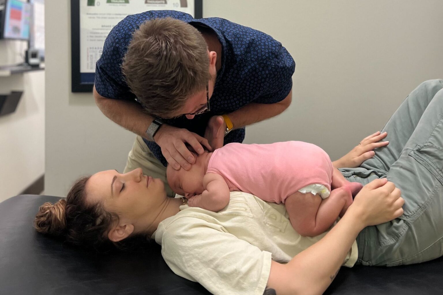 Dr. Anthony Pellegrino performing gentle cranial work on a newborn resting on a parent at the Sea Girt NJ office