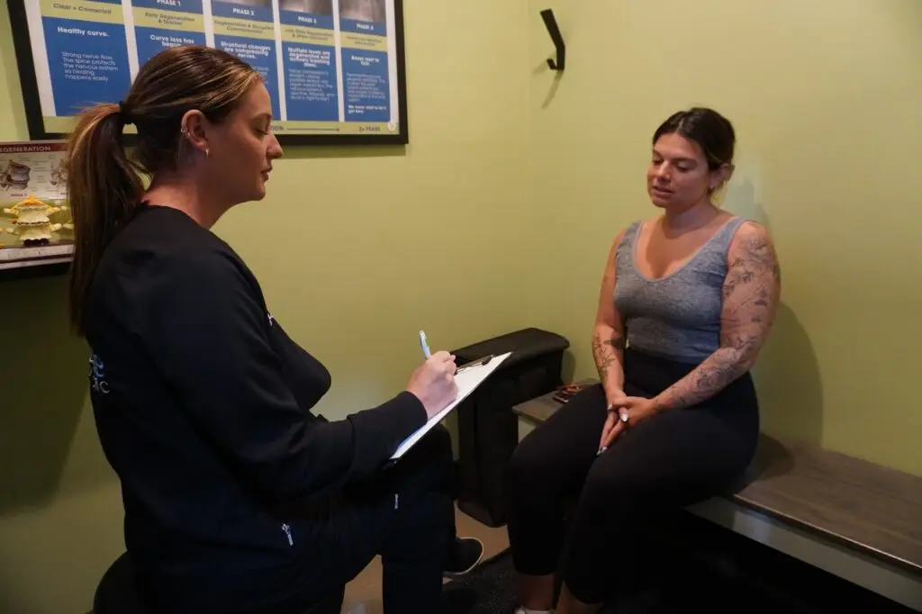 A patient describing jaw symptoms during a consultation at Absolute Chiropractic in Sea Girt